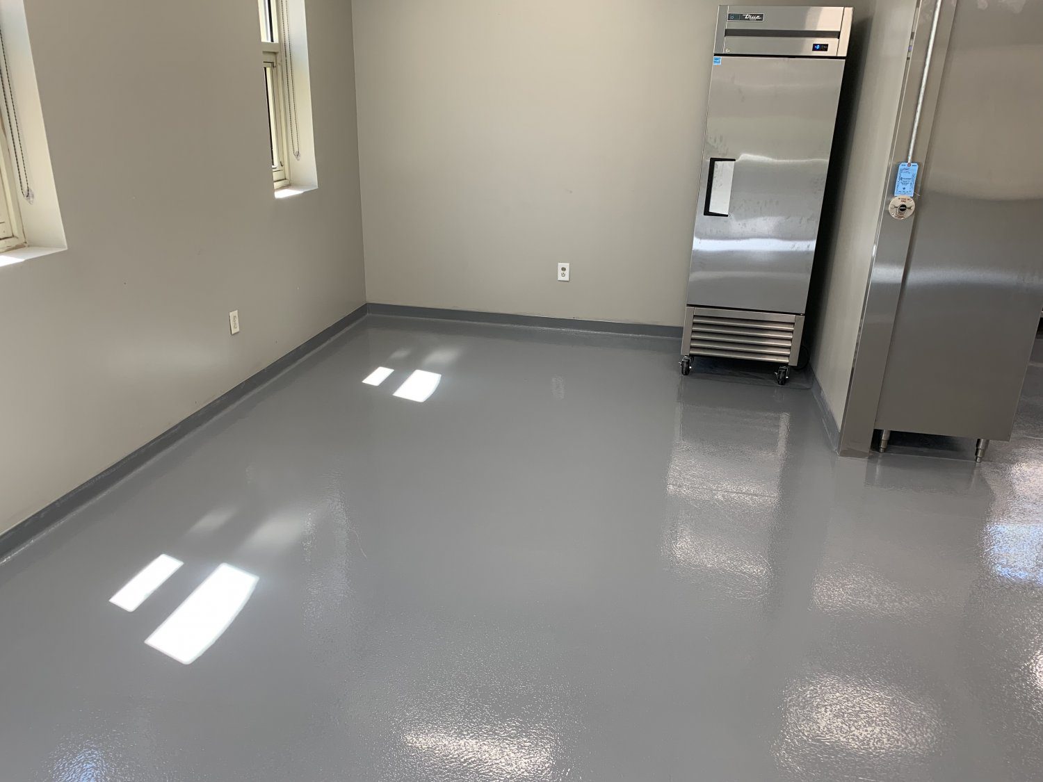 Industrial kitchen with stainless steel fridge