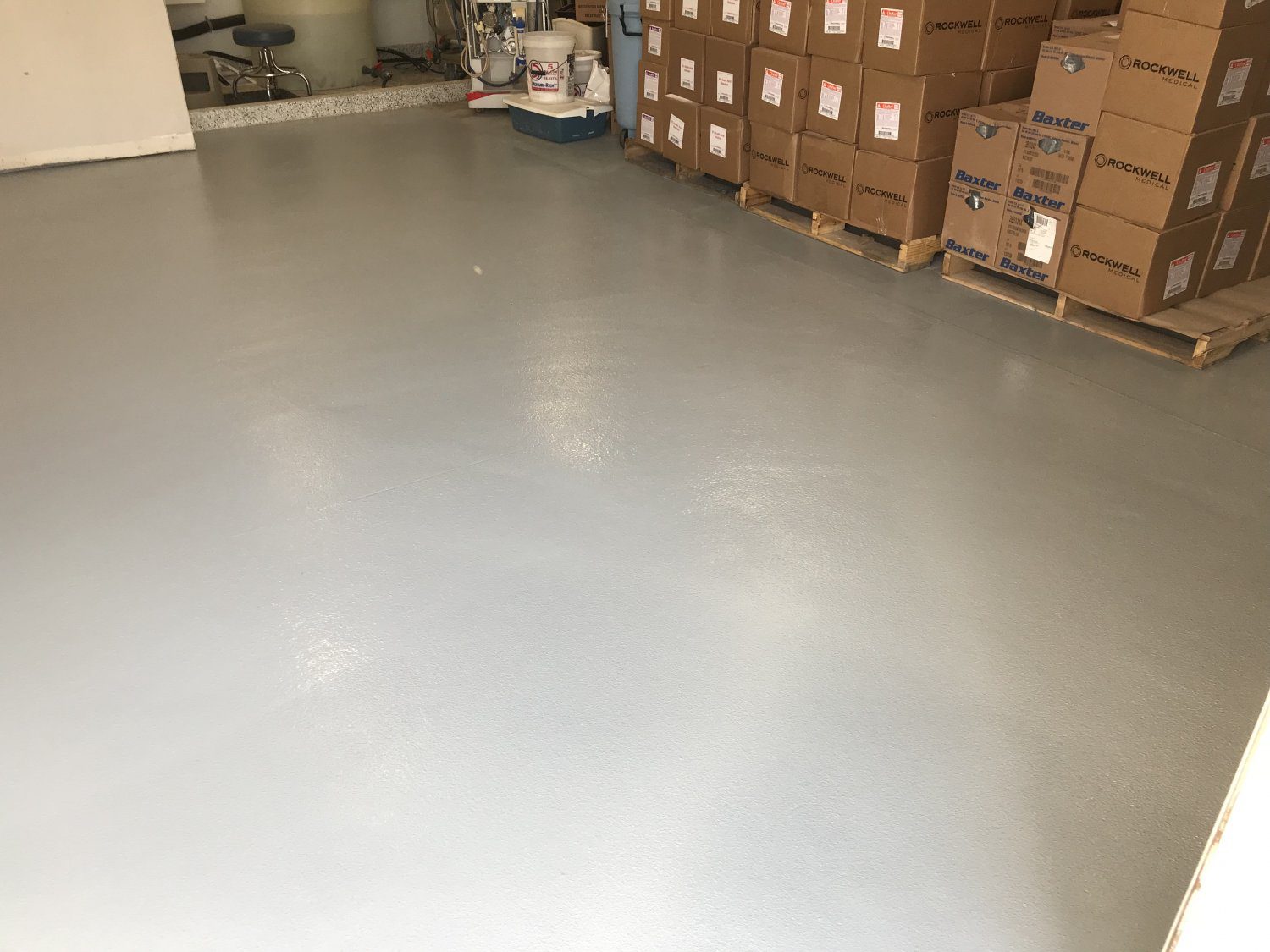 Clean warehouse floor with stacked boxes