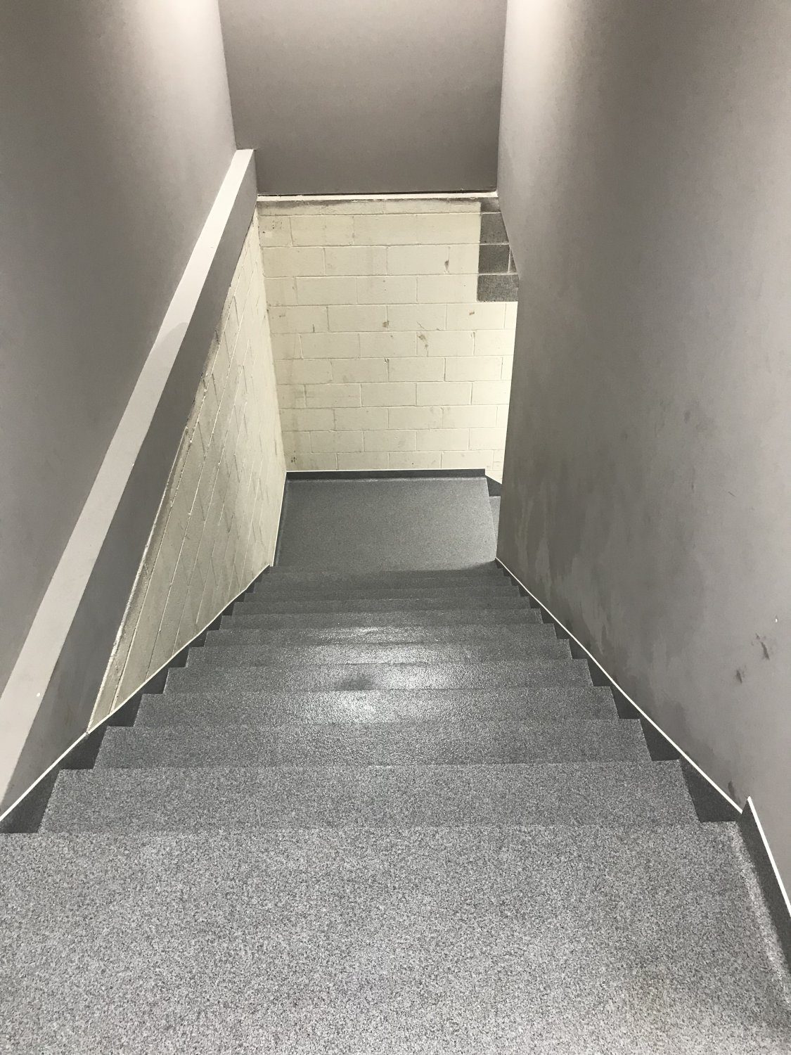 Narrow stairwell with gray steps