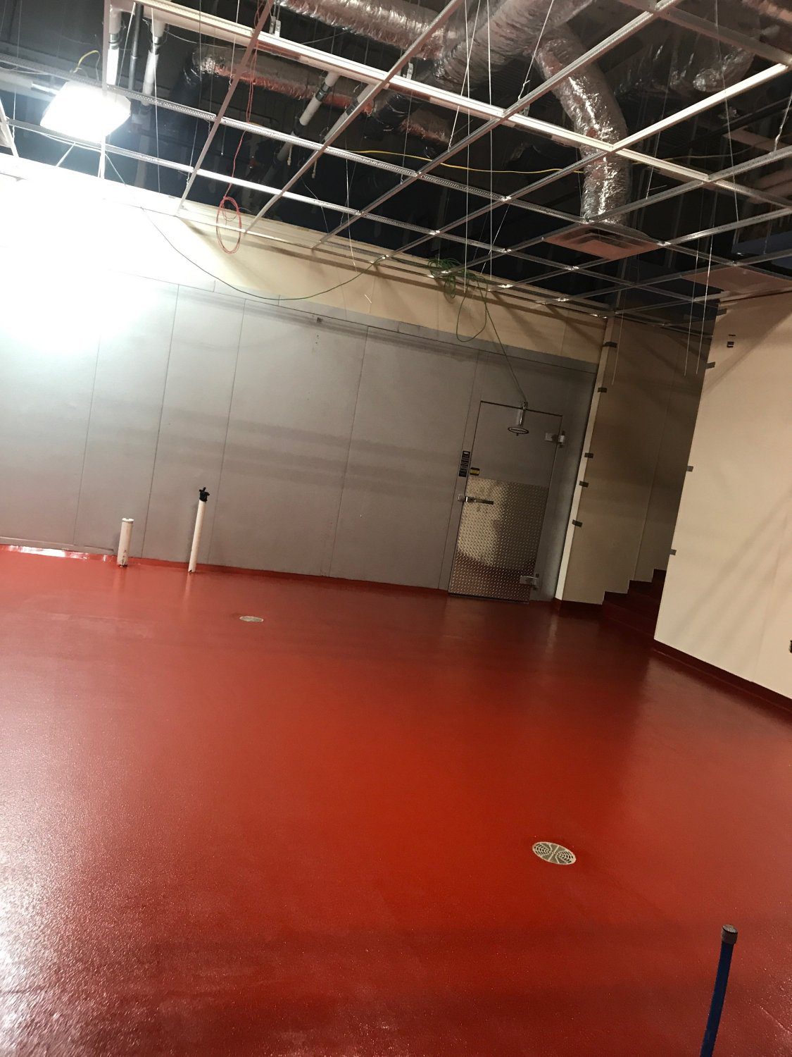 Unfinished room with red flooring