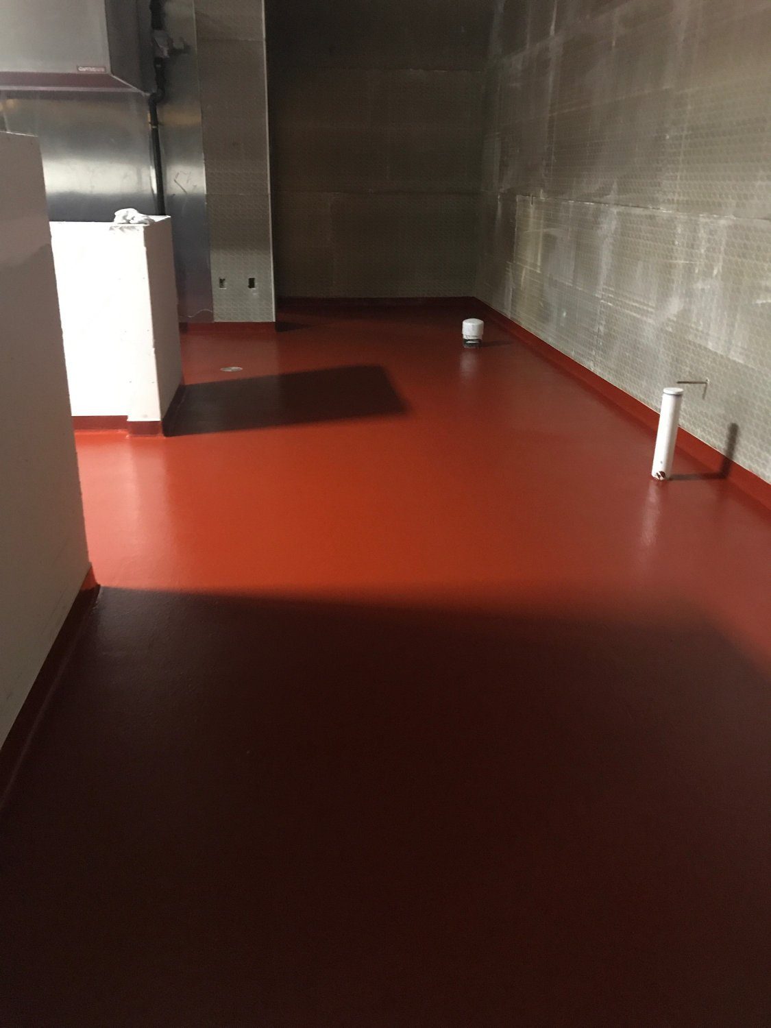 Red epoxy floor in industrial space