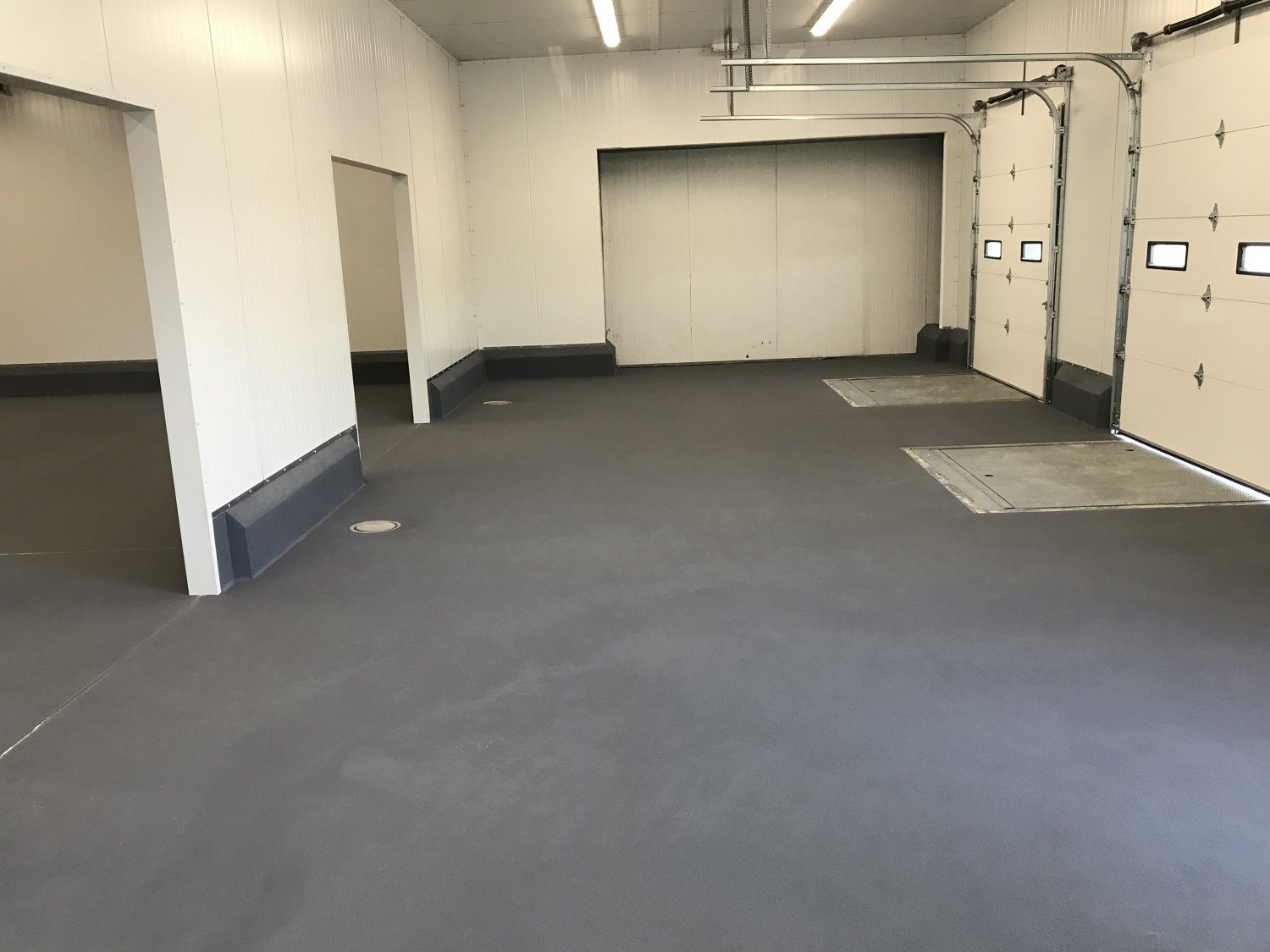 Empty industrial garage with multiple doors