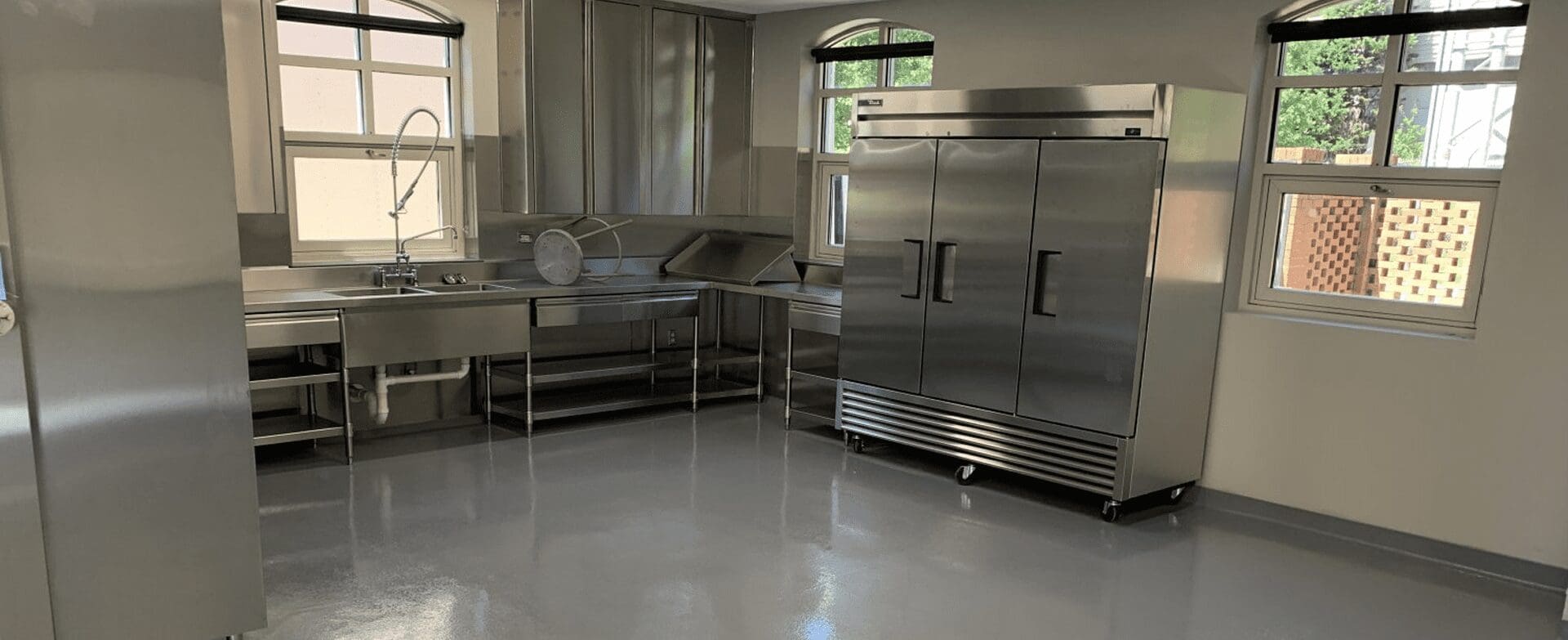 Spacious kitchen area with large refrigerator