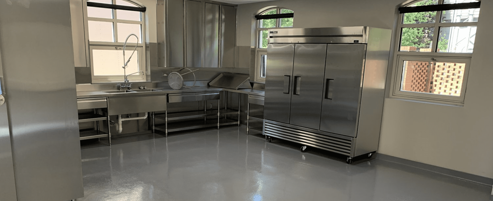 Spacious kitchen area with large refrigerator